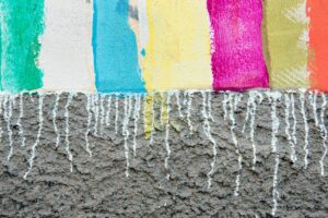 Colorful striped painting on rough concrete